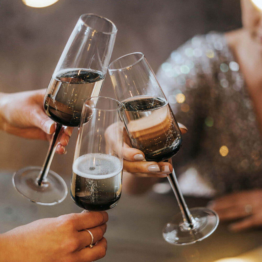 Three people clinking glasses together 